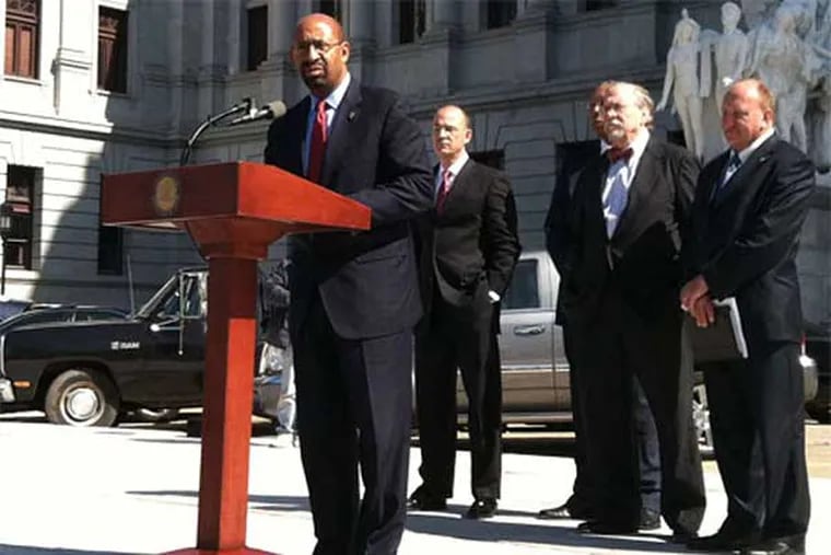 Philadelphia Mayor Michael Nutter spoke in March in Harrisburg, where he joined other Pa. mayors to speak against bills that could end local gun-control laws. (Amy Worden / Staff)