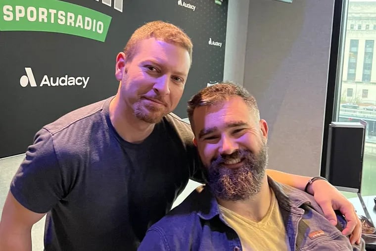 Longtime  94.1 WIP host Jon Johnson (left), seen here earlier this month with Eagles center Jason Kelce, will take over as the station's overnight host.