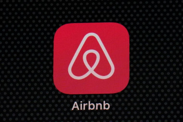 The Airbnb app icon on an iPad screen.