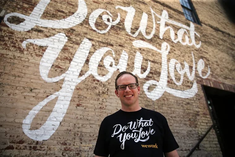 Dave McLaughlin, WeWork's eastern U.S. general manager, poses in front of their logo outside their building in Northern Liberties on May 26, 2016.