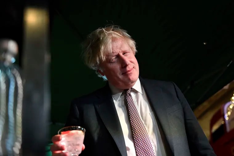 Britain's Prime Minister Boris Johnson samples an Isle of Harris gin as he visits a UK Food and Drinks market, set up in Downing Street, London, Tuesday, Nov. 30, 2021.
