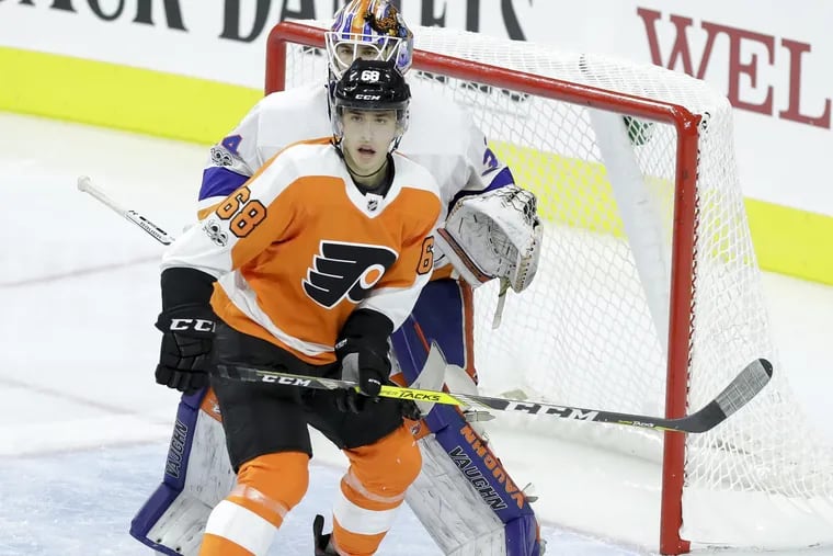 Morgan Frost, one of the Flyers' best prospects, battles for position in an exhibition game against the Islanders last season. Frost will be one of 33 prospects at the Flyers' development camp.