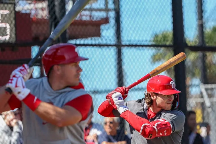 J.T. Realmuto (left) and Alec Bohm are two primary candidates to bat behind Bryce Harper in the Phillies' batting order this season.