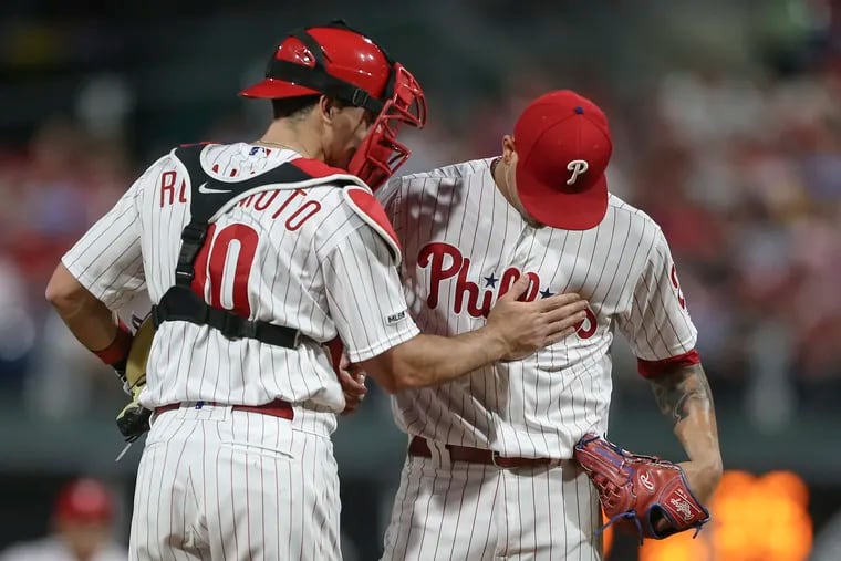 Phillies' catcher J.T. Realmuto consoles pitcher Vince Velasquez after throwing a two-run homer the Tigers' Niko Goodrum during the 3rd inning at Citizens Bank Park in Philadelphia, Tuesday, April 30, 2019