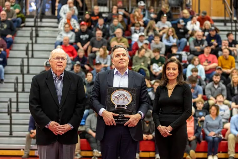 Dave McCormick, a Republican candidate for U.S. Senate, stands with his father, James McCormick, and his wife, Dina Powell, as he is inducted into the PIAA District 4 Wrestling Hall of Fame at Williamsport Area High School on Feb. 24.