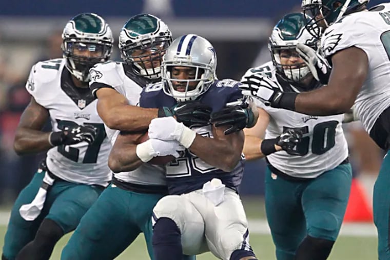Cowboys running back DeMarco Murray is gang tackled by the swarming Eagles defense. (Ron Cortes/Staff Photographer)