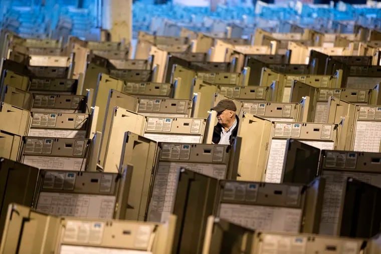 In this 2016 photo, a technician works to prepare voting machines to be used in the presidential election, in Philadelphia.