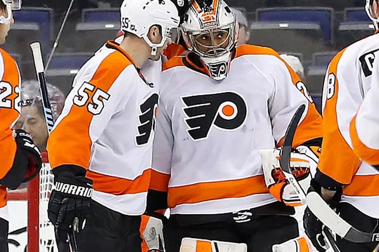 Philadelphia Flyers goalie Ray Emery (29) is congratulated by teammates after the Flyers game against the Washington Capitals at Verizon Center. (Geoff Burke/USA Today)