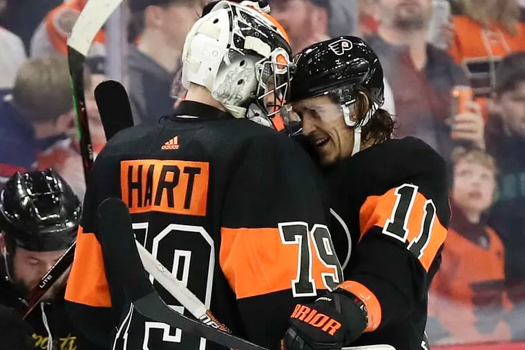 Goaltender Carter Hart, shown celebrating with teammate Travis Konecny after an overtime win over Detroit last month, is getting closer to returning to the Flyers' lineup.