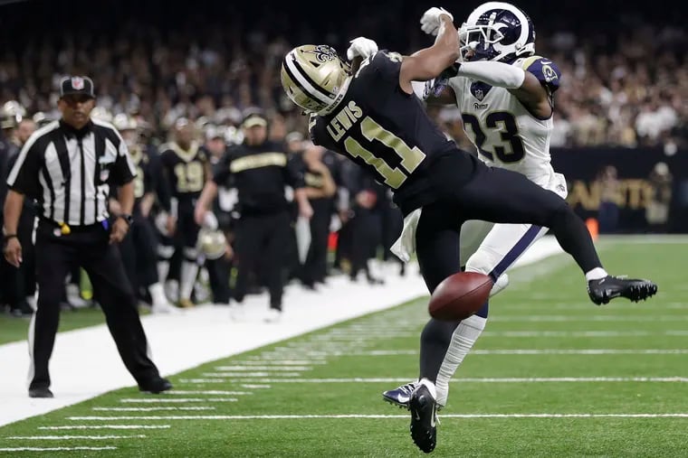 Saints receiver Tommylee Lewis gets hit by Rams defensive back Nickell Robey-Coleman with an official watching. Pass interference wasn't called.
