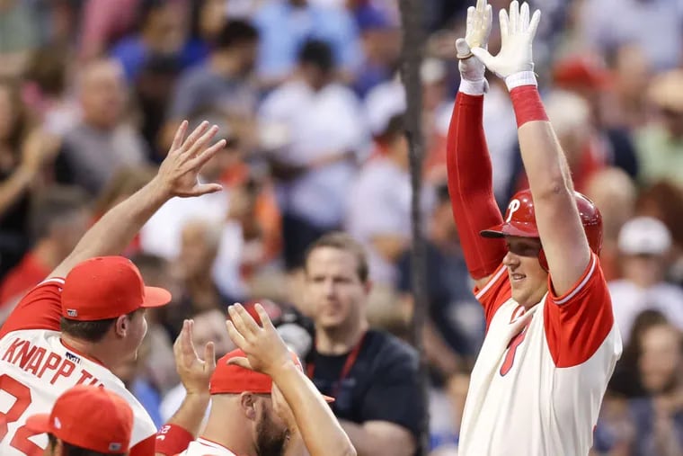 Phillies Rhys Hoskins raises his arms celebrating after hitting a two run first-inning home run against the Chicago Cubs on Friday, August 25, 2017 in Philadelphia.