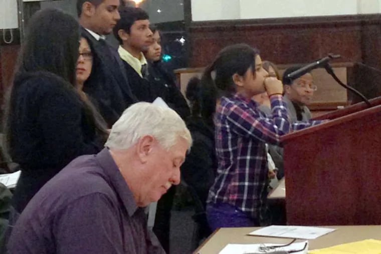 Stepany(cq) Aldana, 11, addresses City council flanked by additional members of the Von Nieda Park Taskforce, as Director of Public Works Pat Keating, front, takes notes on her comments.