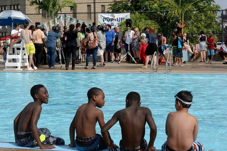 Youngsters wait for the officials’ “Pop-Up Pool” speeches to end so they can get back into the water. (TOM GRALISH / Staff Photographer)