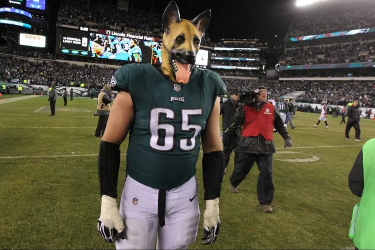Eagle offensive lineman Lane Johnson walks off the field wearing a German Shepherd’s mask celebrating the underdog Eagles’ win over the Falcons on Saturday night.