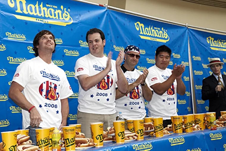 Some QVC employees also took a shot at yesterday's contest in West Chester, including (from left): Ed Campetelli, Vince Freeman, Doug King and Andrew Kneisly.  King was the QVC king, eating 10 hot dogs in 10 minutes.
