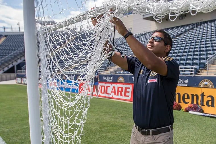 John Torres, head groundkeeper at Talen Energy Stadium releases netting from soccer goal frame. Torres is in charge of maintaining grass in the stadium and practice fields.