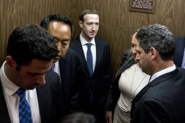 Facebook CEO Mark Zuckerberg (center) leaves a meeting with Sen. John Thune (R., S.D.) on Capitol Hill in Washington, Monday, April 9, 2018. Zuckerberg testified Tuesday before a joint hearing of the Commerce and Judiciary Committees about the use of Facebook data to target American voters in the 2016 election.
