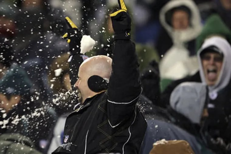A  fan gets hit by a snowball during the Eagles-49ers game on Sunday. (Yong Kim / Staff Photographer)