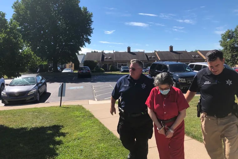 Ana Maria Tolomello is escorted into district court in New Britain ahead of her preliminary hearing Friday. Tolomello has said she acted in self-defense when she shot her long-time boyfriend, Giovanni Gallina, in March.
