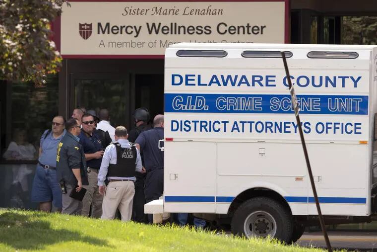 Investigators work the scene of a shooting Thursday, July 24, 2014, at Mercy Fitzgerald Hospital in Darby, Pa. A shooting at the suburban Philadelphia hospital campus has killed one worker and injured two other people. Prosecutor Jack Whelan says one of the injured is the gunman. (AP Photo)