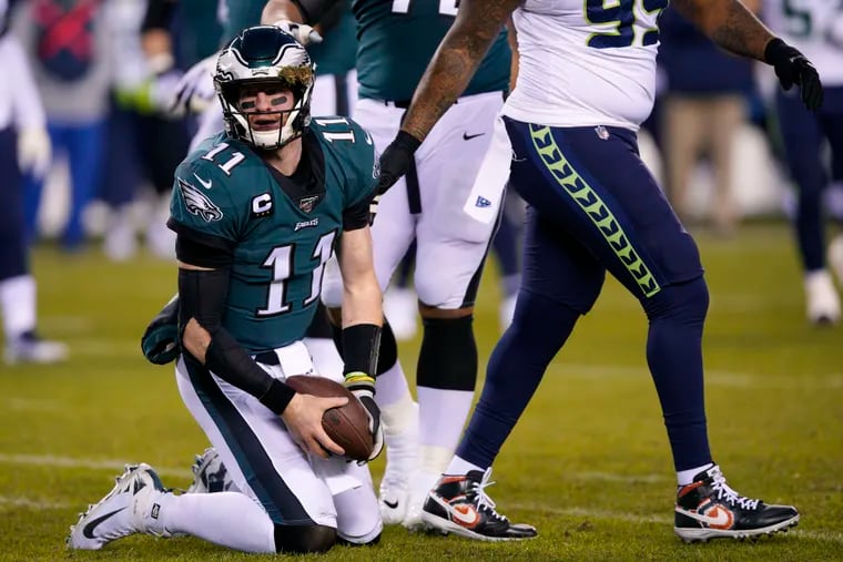 Eagles' Carson Wentz gets up after a hit from Seattle Seahawks' Jadeveon Clowney during the first half of Sunday's Wild Card loss at Lincoln Financial Field (AP Photo/Chris Szagola).