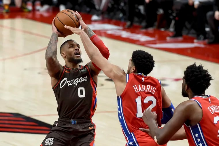 Damian Lillard (left) takes a shot over Sixers forward Tobias Harris (12) earlier this month. The Blazers won, part of the Sixers' 3-6 record vs. winning teams.
