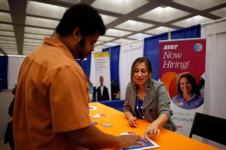 AT&T hiring manager Cathy Zavala (R) talks to Jose Blackman, 38, who was laid off last year and is looking for a job to support his two children, in Los Angeles, California April 9, 2014. (REUTERS/Lucy Nicholson)