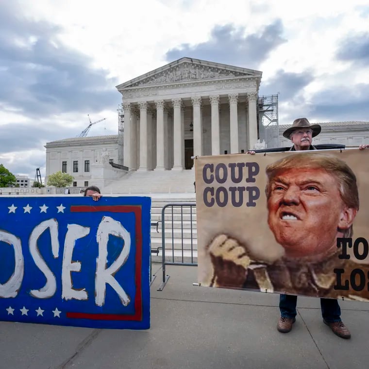 Activist Stephen Parlato of Boulder, Colo., right, joins other protesters outside the Supreme Court as the justices prepare to hear arguments over whether Donald Trump is immune from prosecution in a case charging him with plotting to overturn the results of the 2020 presidential election, on Capitol Hill in Washington on Thursday.