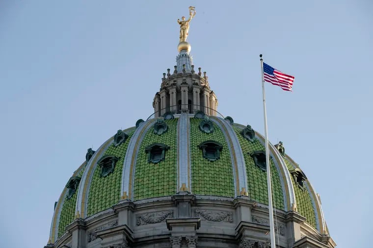 In this Jan. 15, 2019, file photo an America flag flies at the Pennsylvania Capitol building in Harrisburg, Pa. The rights of crime victims would be enshrined in the Pennsylvania Constitution under a proposed amendment that could go before the state’s voters later this year, but opponents warn the change has the potential to end up violating the rights of criminal defendants.