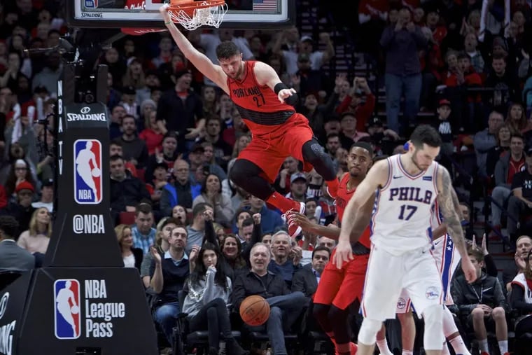 Blazers center Jusuf Nurkic dunks as Sixers guard JJ Redick (right) gets back on offense during the Sixers’ 114-110 loss to Portland.
