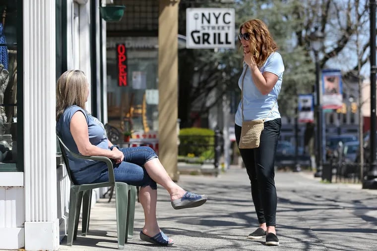 Stroudsburg Mayor Tarah Probst, right, talks with shop owner Paula Fitzpatrick on Main Street in in the Pennsylvania town on April 8. Probst is the first Democrat and woman elected to head the Monroe County town. An influx of out-of-staters is making the Poconos region more Democratic-leaning.