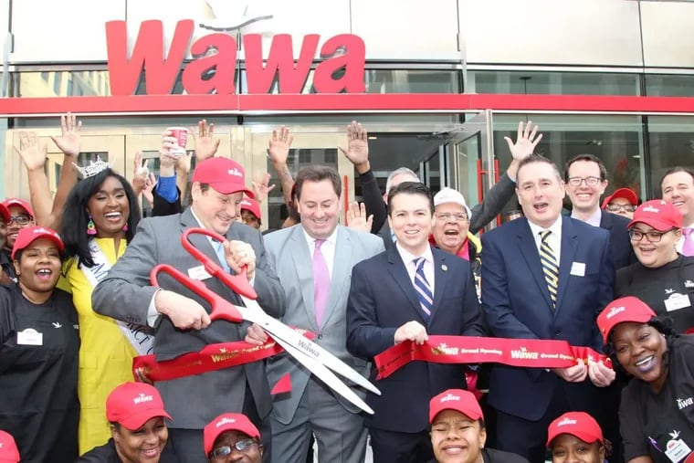 Officials including Wawa CEO Chris Gheysens, center, and U.S. Rep. Brendan Boyle, pictured to the right of Gheysens, celebrate the grand opening of Wawa’s D.C. location Thursday.
