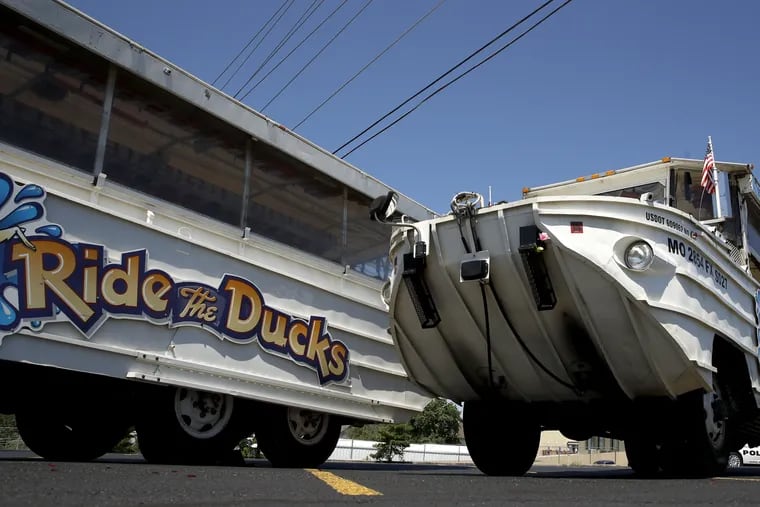 A man looks at an idled duck boat in the parking lot of Ride the Ducks Saturday, July 21, 2018 in Branson, Mo. One of the company's duck boats capsized Thursday night resulting in several deaths on Table Rock Lake. (AP Photo/Charlie Riedel)