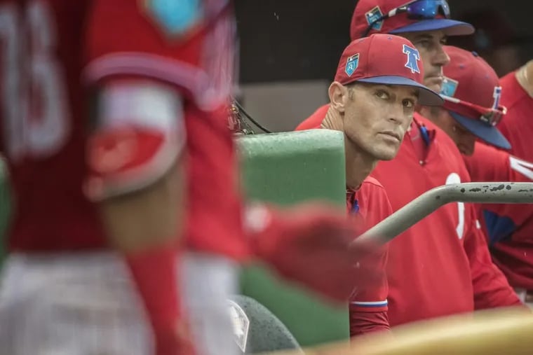 Phillies manager Gabe Kapler, center, keeps his eyes on Phillies right fielder, Jesmuel Valetin, left, as he gets ready to bat against the Toronto Blue Jays on March 20, 2018, during a spring training game.