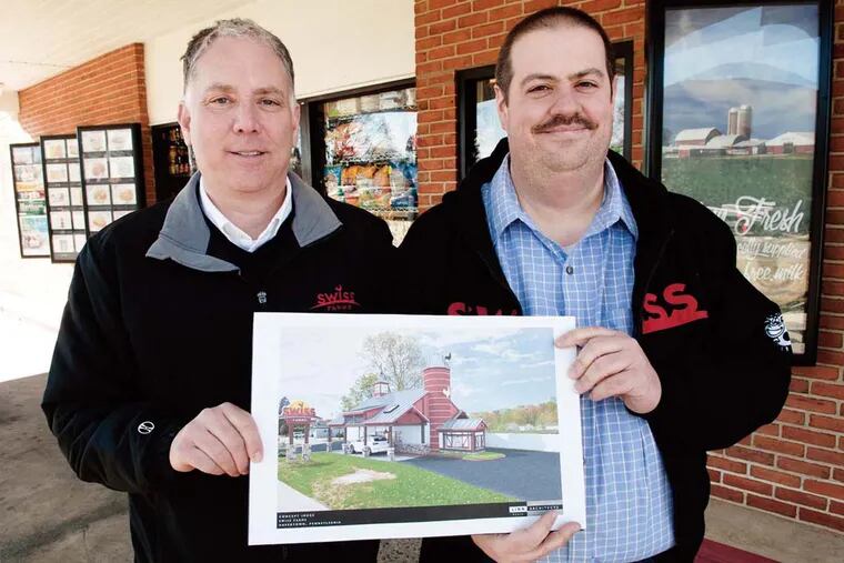Swiss Farms CEO Scott Simon (left) and architect Michael Cosentino hold an architectural drawing for a renovation of the store on North Eagle Road in Havertown.