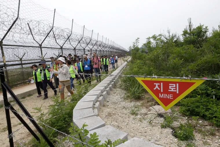 In this June 14, 2019, file photo, hikers and journalists walk along the DMZ Peace Trail in the demilitarized zone in Goseong, South Korea. Eyeing a history-making photo opportunity, U.S. President Donald Trump on Saturday, June 29, 2019, issued a Twitter invitation to North Korea's Kim Jong Un to join him for a hand shake during a visit by Trump to the demilitarized zone with South Korea.