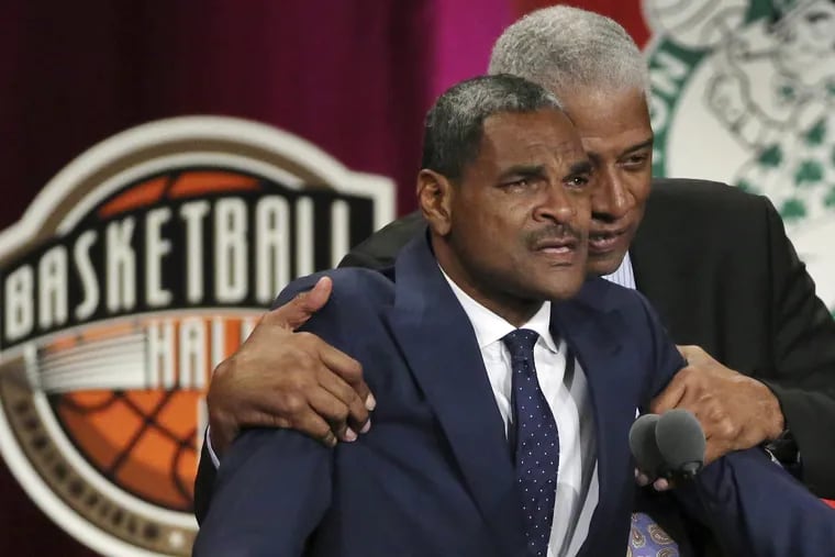 Maurice Cheeks (left) is hugged by fellow Hall of Famer Julius Erving as he becomes emotional during his induction speech at the Basketball Hall of Fame Friday night.