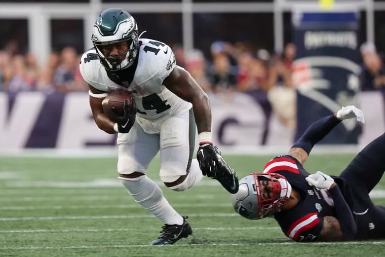 Eagles running back Kenneth Gainwell  is tripped up by New England Patriots linebacker Ja'Whaun Bentley  in the third quarter at Gillette Stadium.