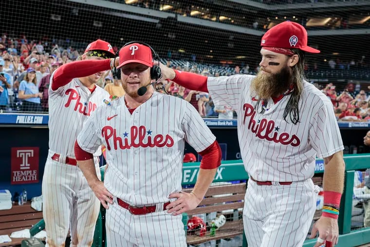 Phillies pitcher Craig Kimbrel center gets a water and can bath from teammates Bryson Stott left and Brandon Marsh after beating the Braves 7-5 in Game 2 of a double header at Citizens Bank Park in Philadelphia,  Monday, Sept. 11, 2023