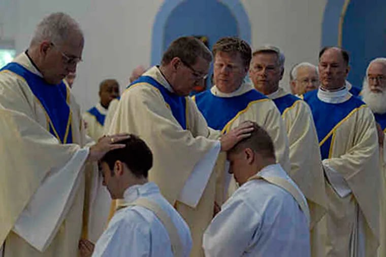 Priests lay hands on John Rossi (left) and Lawrence Polansky during their ordination at St. Peter Celestine Church in Cherry Hill. Bishop Galante's bold plan to revitalize -- and downsize -- the diocese is about to begin. (Ron Tarver / Staff)