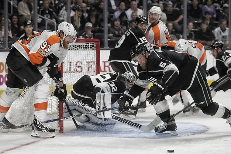 The Los Angeles Kings’ Jake Muzzin (6) keeps his eye on the puck as he tries to keep the Philadelphia Flyers’ Jakub Voracek, left, at bay in the second period at Staples Center in Los Angeles on Thursday, Oct. 5, 2017.