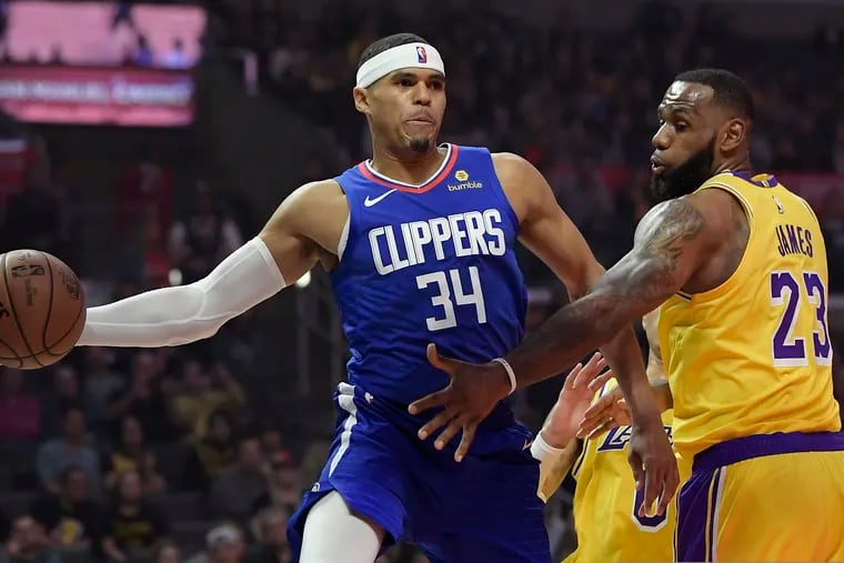 Tobias Harris (left) passes the ball around Lakers forward LeBron James during a game last month. The Sixers acquired Harris in a trade with the Clippers early Wednesday.