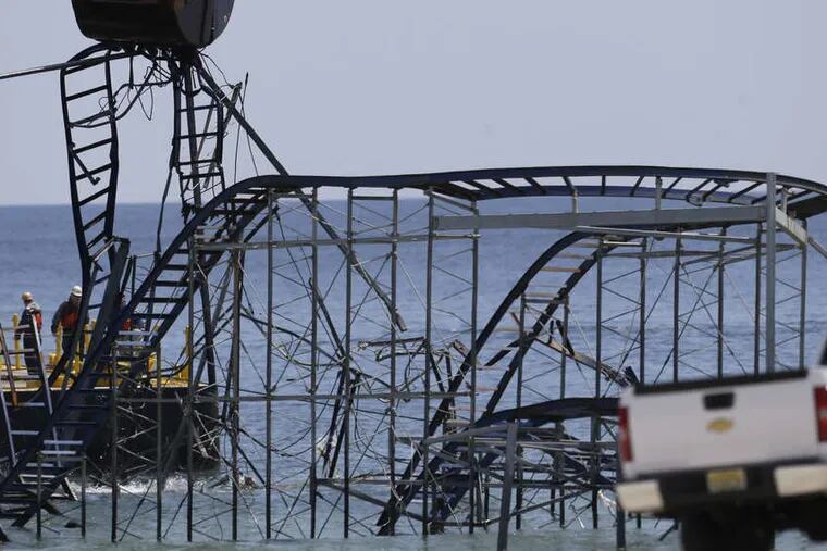 ASSOCIATED PRESS Like one of those boardwalk games in which a claw picks up (or usually doesn't) some tacky prize, a crane picks apart the landmark Jet Star Roller Coaster in Seaside Heights, a Superstorm Sandy victim.