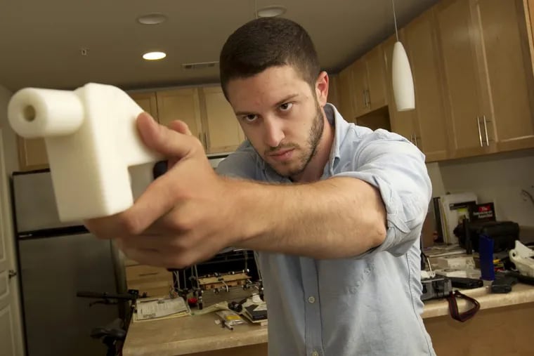 Cody Wilson shows the first completely 3D-printed handgun, The Liberator, at his home in Austin, Texas on Friday May 10, 2013.