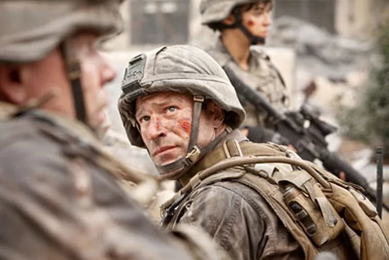 Aaron Eckhart and Michelle Rodriguez (background) play Marines fighting aliens from space.