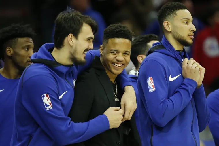 Sixers guard Markelle Fultz smiles with teammates Dario Saric (left) and Ben Simmons (right) late in Friday’s win over the Pistons.