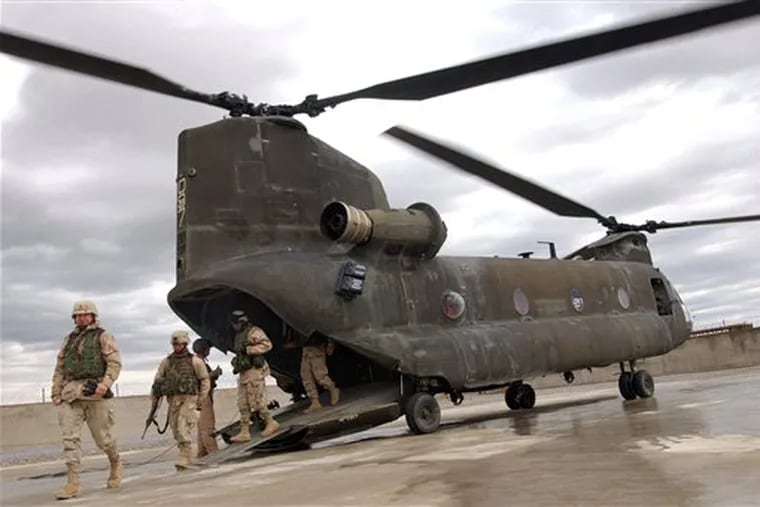 U.S. soldiers embark from a CH-47 Chinook military helicopter to take part in the ground opening of Lashkar Gah's PRT (Provincial Reconstruction Team) of Helmand province, southern Afghanistan, in this March 19, 2005 file photo. (AP Photo/Musadeq Sadeq, File)