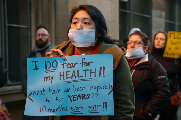 Hee Young Yim, an art teacher at Franklin Learning Center, protests with students, teachers, and parents outside the school on N. 15th Street in Philadelphia. FLC was closed because of damaged asbestos in late December; teachers, parents and students protested the decision to bring them back Jan. 2 to a building they say is still unsafe.