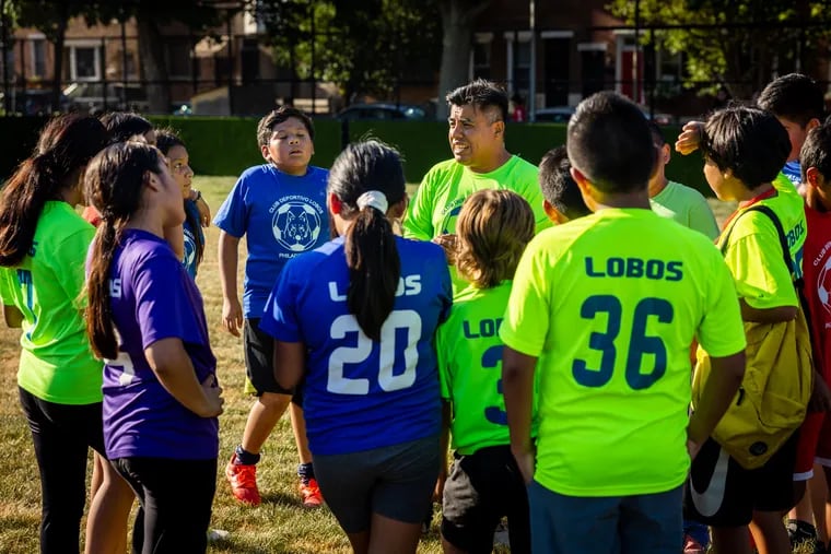 Luis Uribe with members of the Club Deportivo Los Lobos at the July 2022 ribbon-cutting of the mini soccer pitch at Capitolo Playground in South Philly. The pitch is one of 15 Rebuild has planned to build across the city.