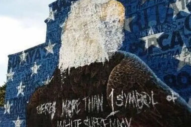 Mural of American bald eagle defaced by vandals.